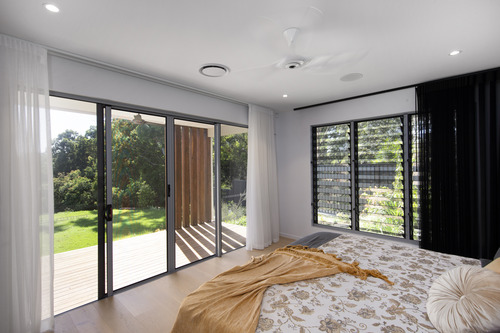 Inside of a bedroom protected by forcefield security screens and overlooking the back yard